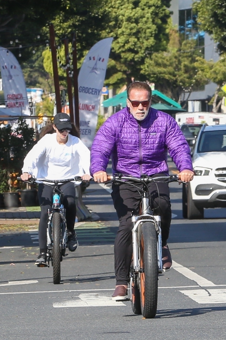 Arnold Schwarzenegger and his daughter Christina go out for a bike ride