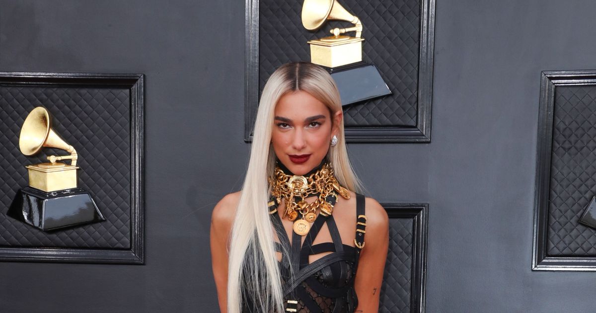ICYMI: Dua Lipa's black leather bondage look from Versace, plus more celebrities on the 2022 Grammy Awards red carpet.jpg