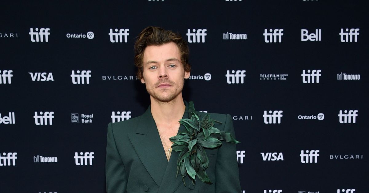 Harry Styles goes shirtless under his floral-embellish green Gucci blazer — and carries a purse — at 'My Policeman' TIFF premiere, plus more of his most playful fashion moments.jpg