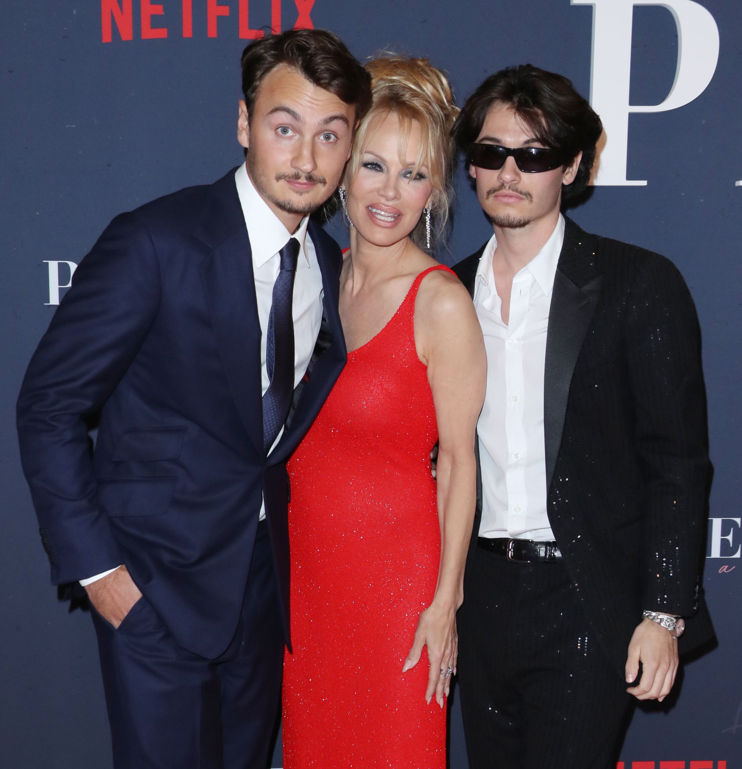 Pamela Anderson brings adult sons with Tommy Lee to her movie